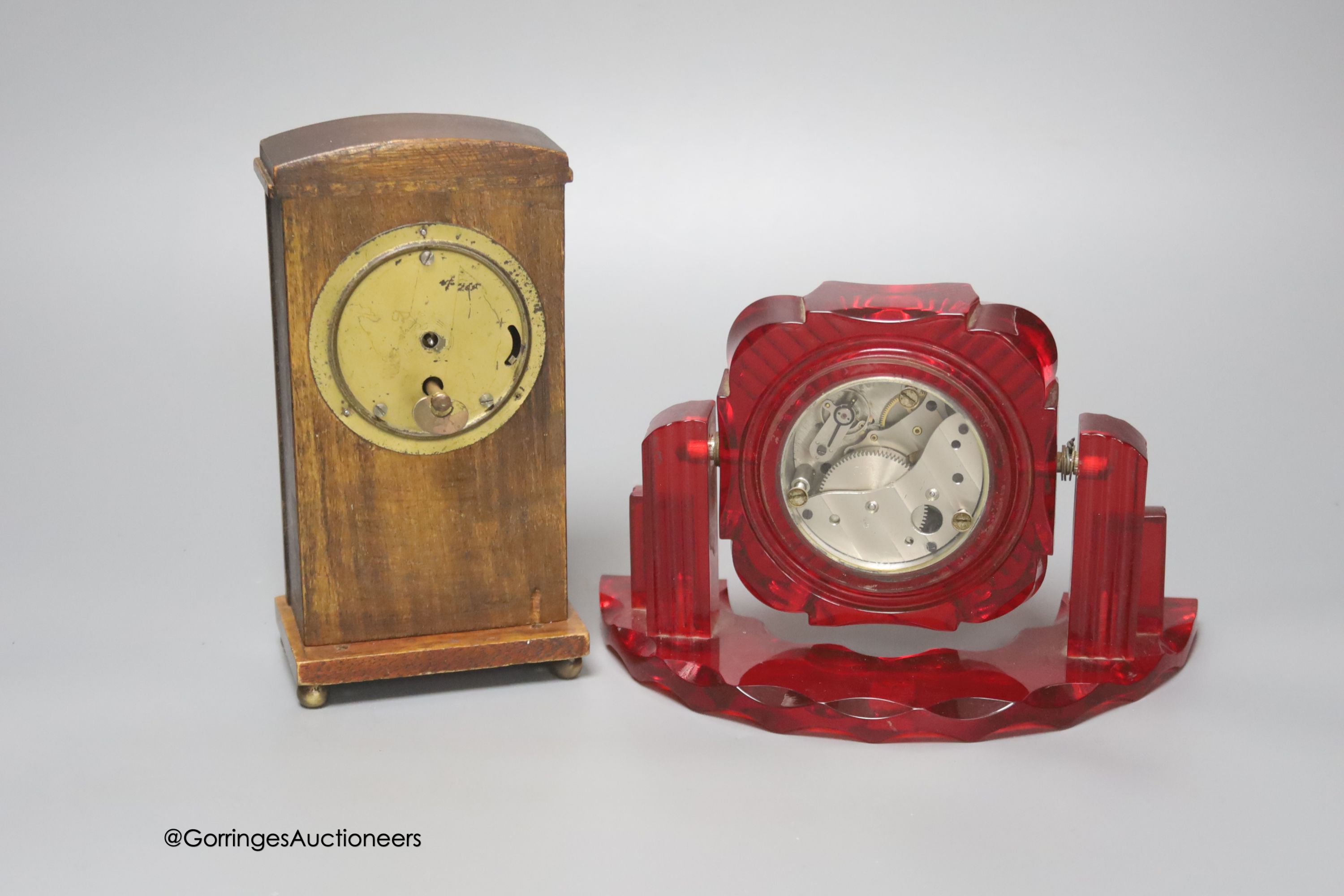 A Russian moulded red acrylic mantel timepiece, width 19cm, and a Secessionist style beech cased timepiece